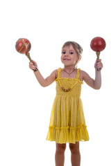 Little girl in a bright yellow dress with maracas in her hands. Studio photo, bright white background.