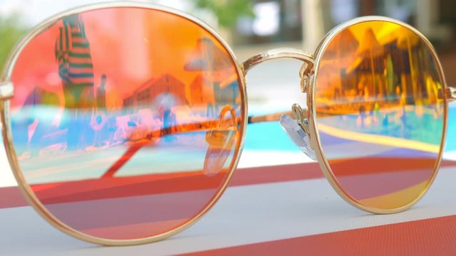 Sunglasses. Pool reflection. Concept of holiday at sea. Observations children, play.