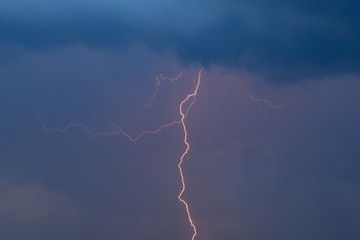The discharge of lightning in the sky as a background