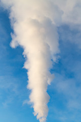 Fototapeta na wymiar smoke from a pipe in the factory against a blue sky