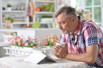 Mature man using tablet 