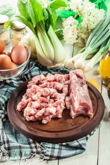 Raw pork belly pieces on a cutting board