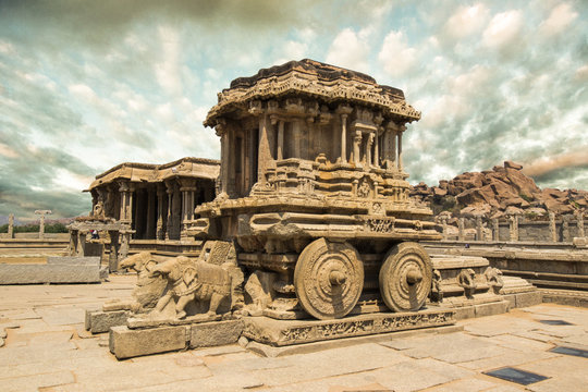 The most iconic stone chariot from Hampi, Karnataka, India with ta backdrop of Indian monsoon clouds