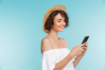 Portrait of a smiling young woman in summer hat