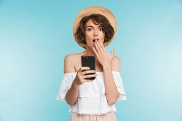 Portrait of a surprised young woman in summer hat