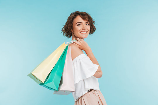 Portrait of a smiling young woman holding shopping bags