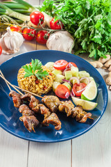 Traditional pork satay with peanut sauce and vegetables