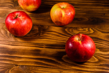 Ripe red apples on the wooden table