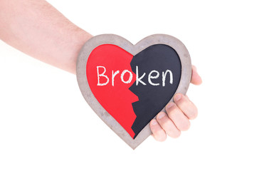 Adult holding heart shaped chalkboard - Broken