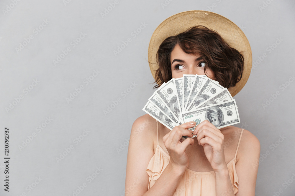 Wall mural Portrait of a pretty young woman in summer hat