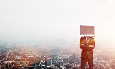 Businessman with laptop instead of head.