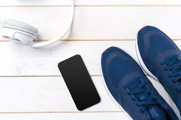 Sneakers and mobile phone with headphones