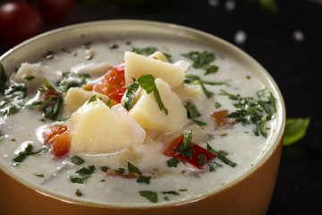 Potatoes soup with different vegetables and sour cream