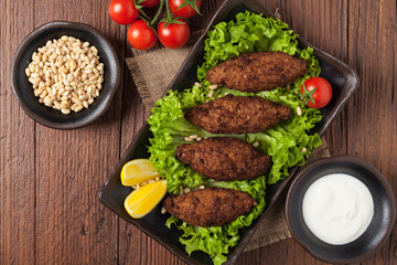 Traditional arabic kibbeh with lamb and pine nuts.