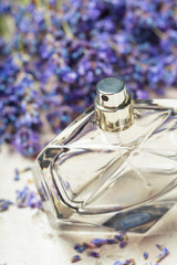 woman perfume in beautiful bottle and lavender flowers