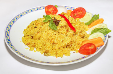 Indian meal of vegetable fried pulao rice served with salad isolated on white background.