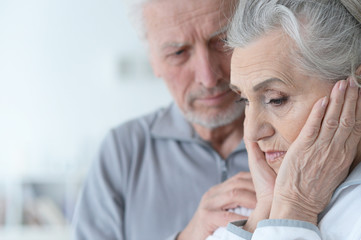 Sad Senior couple at home 