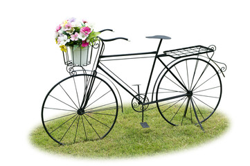 Fototapeta premium Vintage bicycle on green grass isolated on white background.