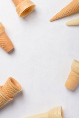Wafer cones for ice cream empty clean new on white table background top view flatlay with copy space