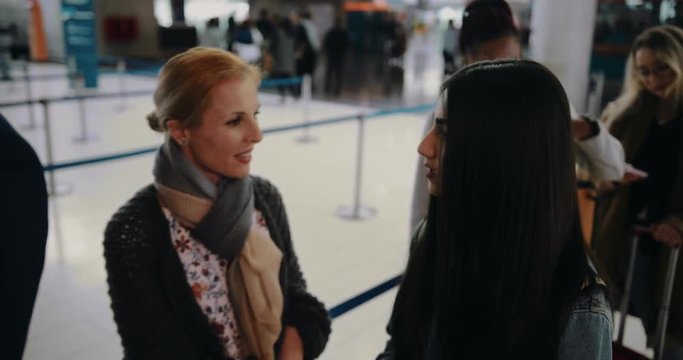 Multi-ethnic people waiting in queue at airport