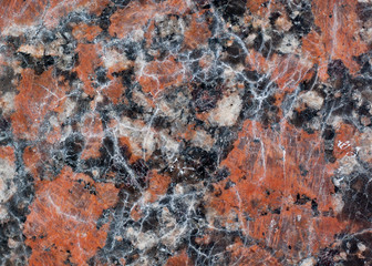 Reddish-brown granite texture with black and gray spots. Used as a background.