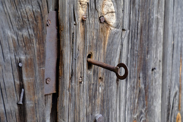 old wooden door with a rusty key