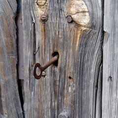 old wooden door with a rusty key