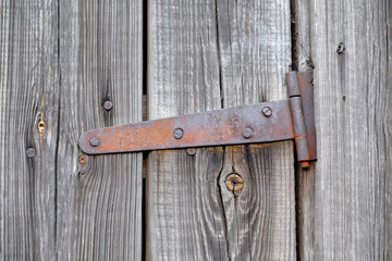 old wooden door with a rusty loop