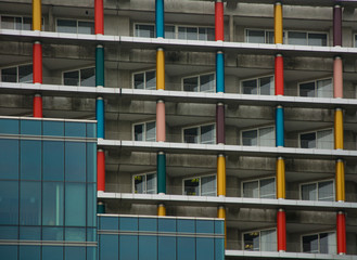 Balconies of the skyscraper with colored columns.