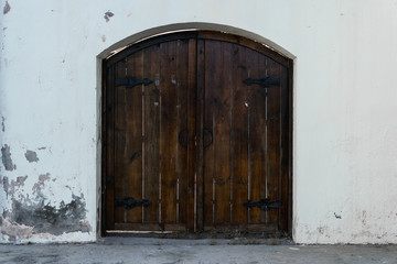 old wooden door in a white wall