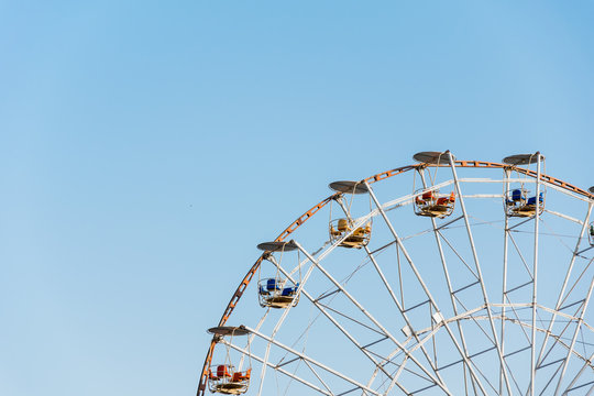 Ferris wheel on blue sky background