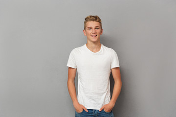 Portrait of a smiling relaxed teenage boy - obrazy, fototapety, plakaty