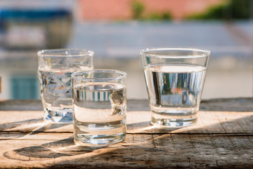Drink a glass of water on a wooden floor.