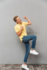 Full length portrait of an excited teenage boy