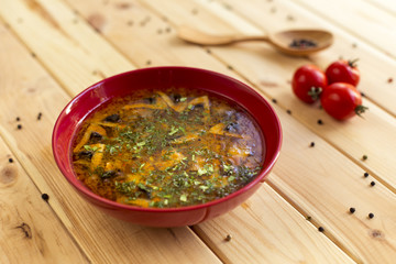 Soup with mushrooms on a wooden background
