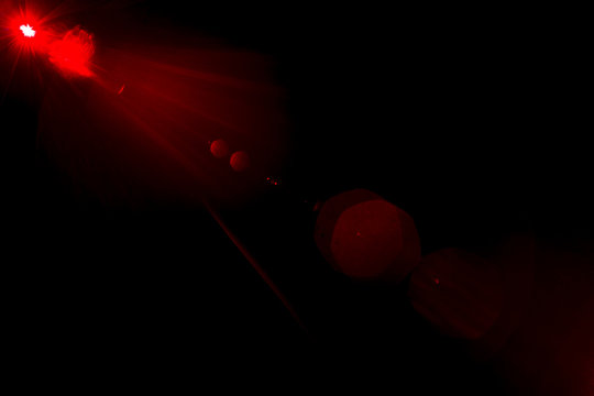 Camera lens flare by laser light create hexagons of objective iris shapes of number depending on number of lens surface and interference effect and moire on digital sensor on dark black background