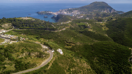 Aerial view of Ponza, island of the Italian Pontine Islands archipelago in the Tyrrhenian Sea, Italy. On the island there are few houses between the Mediterranean vegetation and the sea.