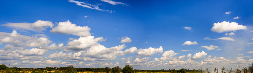 A curly summer clouds on blue sky background