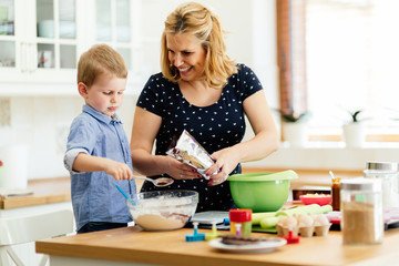 Mother and child preparing cookies