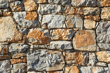 Mediterranean style stone wall with tiles in Greece