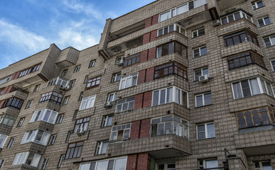 Soviet apartment building. Apartment block. Residential building. Soviet architectural style. 1980s. Blue sky. Ust-Kamenogorsk (Kazakhstan)