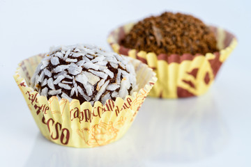 Homemade sweet chocolate coconut truffles on light background