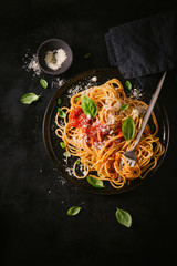 Dark plate with italian spaghetti on dark