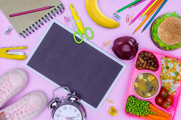 top view of blackboard and tray with kids lunch for school on purple tabletop