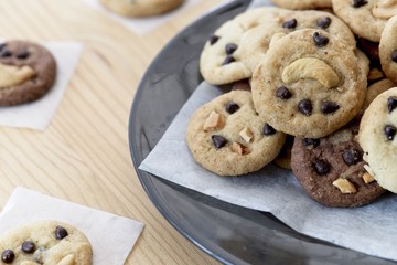 Delicious Chocolate Chip Cookies on black plate, Tasty Homemade cookies on wooden table, dessert with checkered tablecloth.