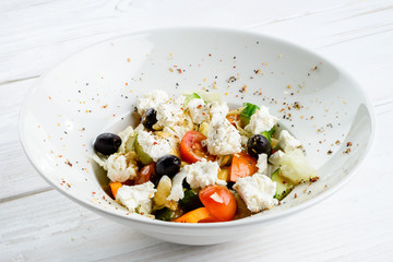 Appetizing vegetarian salad with feta cheese, tomatoes, cucumber