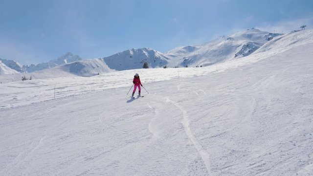 Elegant Woman Alpine Skier Skiing Down The Slope In Mountains