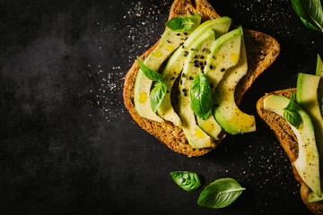 Naklejka na ściany i meble From above avocado toasts for breakfast