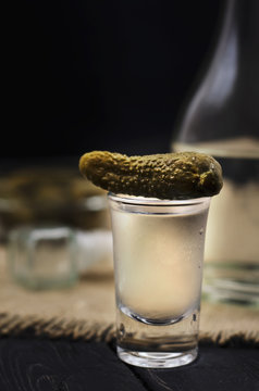 Russian ice vodka in small glass with black bread and pickles