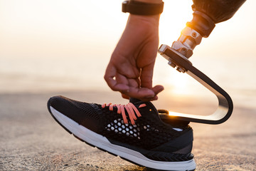 Close up of disabled athlete woman with prosthetic leg